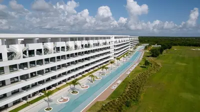 an external view of a large building with a swimming pool at Caribbean Heaven in Punta Cana
