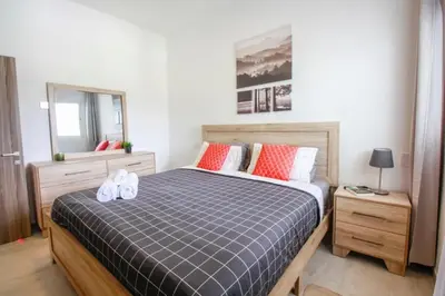 a bedroom with a bed with two towels on it at New Apartment! Beach getaway at Hard Rock in Punta Cana