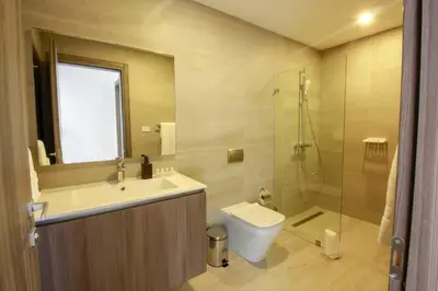 a bathroom with a sink and a toilet and a shower at New Apartment! Beach getaway at Hard Rock in Punta Cana