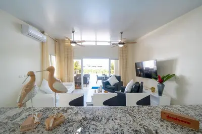 a living room with a couch and a living room with a table at AC in Living Room, Infinity, Pool Luxury in Sosúa
