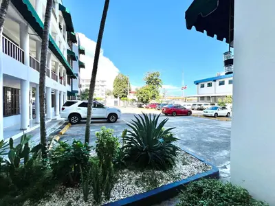 a street with cars parked in a parking lot at Alojamiento cerca de Agora y Blue Mall y Cine etc in Santo Domingo