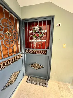 a front door of a house with a gate at Alojamiento cerca de Agora y Blue Mall y Cine etc in Santo Domingo