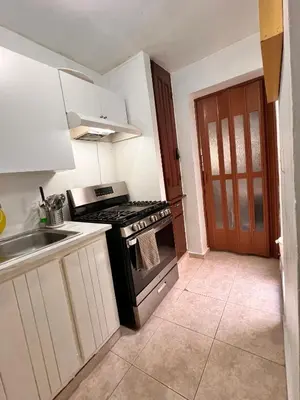 a kitchen with a stove top oven next to a sink at Alojamiento cerca de Agora y Blue Mall y Cine etc in Santo Domingo