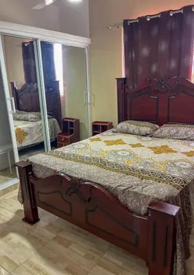 a bedroom with a large bed and a large mirror at Ocean Vibes - Bayahibe in Bayahibe