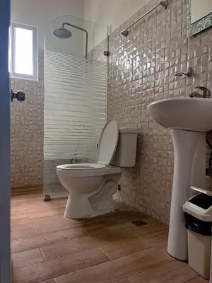 a bathroom with a toilet and a sink at Ocean Vibes - Bayahibe in Bayahibe