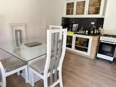 a kitchen with a glass table and a stove at La placita in Santa Bárbara de Samaná