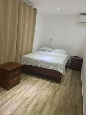 a bedroom with a bed and two nightstands and a bed sidx sidx sidx at La placita in Santa Bárbara de Samaná
