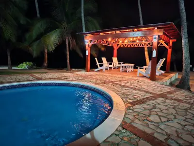 a swimming pool with a gazebo and a table and chairs at Apartamento frente al mar en Albatros in Villas del Mar