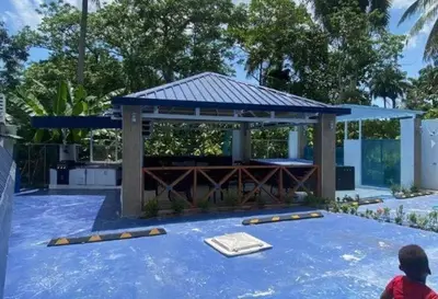 a gazebo with a table on a blue patio at Villa Machepa