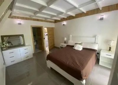 a bedroom with a large bed and a mirror at Villa Machepa