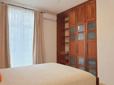 a bedroom with a bed and a large window at Cabarete Beach Palace 3-BDR Condo in Cabarete