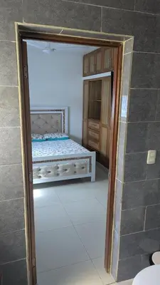 a room with a bedroom with a bed and a mirror at Mitaly apartamentos RD H in Santo Domingo