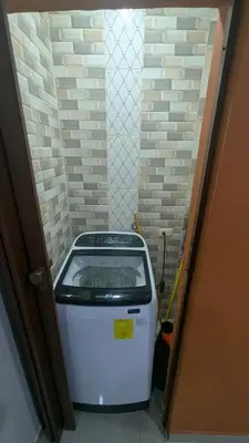 a washing machine in a room with a doorway at Mitaly apartamentos RD H in Santo Domingo