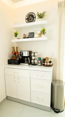 a kitchen with white shelves and a coffee station at Luxurious PH, Near Airport,Private Jacuzzi in Santiago de los Caballeros