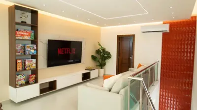 a living room with a tv on a wall at Luxurious PH, Near Airport,Private Jacuzzi in Santiago de los Caballeros