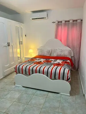 two twin beds in a room with a window at Apartamento in Boca Chica