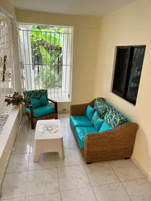 a living room with a couch and a table at Apartamento in Boca Chica