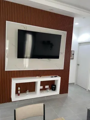 a flat screen tv on a wall in a living room at Villa macao in Punta Cana