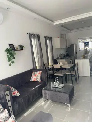 a living room with a couch and a table at Villa macao in Punta Cana