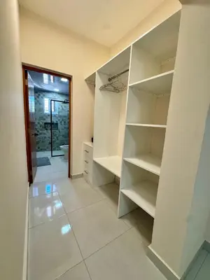 a walk in closet with white shelves in a room at Your ideal escape in Puerto Plata Beach and fun in San Felipe de Puerto Plata
