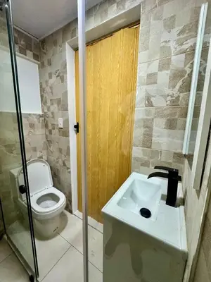 a bathroom with a toilet and a sink at Affordable room near the beach in San Felipe de Puerto Plata