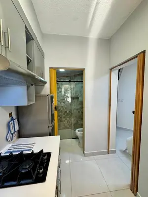 a kitchen with a sink and a toilet in a room at Affordable room near the beach in San Felipe de Puerto Plata
