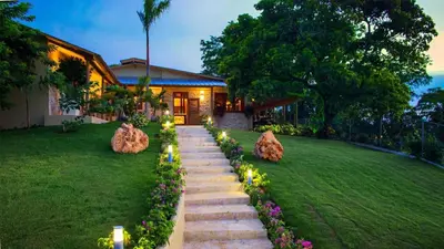 a garden with stone steps and lights in front of a house at Residencial Hispaniola2 MastersMaidPoolBBQ in Sosúa