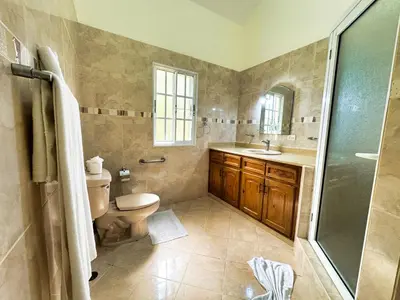 a bathroom with a toilet and a sink and a shower at Residencial Hispaniola2 MastersMaidPoolBBQ in Sosúa