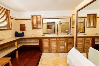 a bathroom with two sinks and two mirrors at Villa Aurore Las Terrenas, Las Ballenas beach in Las Terrenas