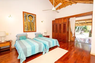 a bedroom with a bed and a painting on the wall at Villa Aurore Las Terrenas, Las Ballenas beach in Las Terrenas