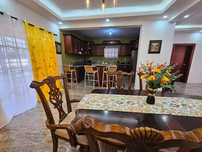 a dining room and kitchen with a table and chairs at Magnificent accommodation in Puerto Plata