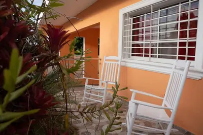 two white chairs sitting in front of a window at Magnificent accommodation in Puerto Plata