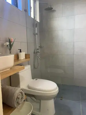a bathroom with a white toilet and a shower at Beautiful luxury apartment in San Juan de la M in SJM