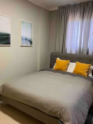 a large bed with yellow pillows in a bedroom at Beautiful luxury apartment in San Juan de la M in SJM