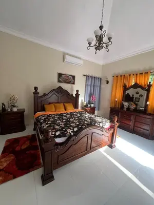 a bedroom with a large wooden bed and a mirror at House with Pool and Calm in La Romana