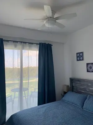a bedroom with a ceiling fan and a bed at Casual and comfort condo at Cana Rock Condos in Punta Cana