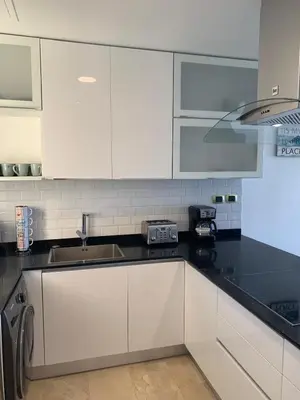 a kitchen with white cabinets and a sink at Casual and comfort condo at Cana Rock Condos in Punta Cana