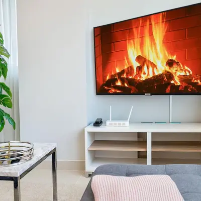 a living room with a fireplace with a tv at Cozy, City Center Condo in Santo Domingo