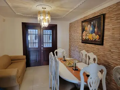 a dining room with a table and chairs and a couch at Apartamento Minimalista in Santiago de los Caballeros