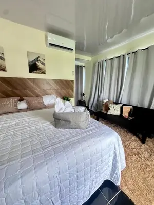 a bedroom with a large white bed and a couch at Villa Seven in Guerra