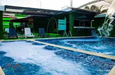 a large swimming pool with a water fountain at Villa en Pedernales in Pedernales