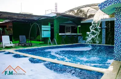 a swimming pool with a water fountain at Villa en Pedernales in Pedernales