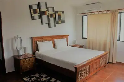 a bedroom with a large bed with white sheets at Natural Pool Villa perfect for families in Río San Juan