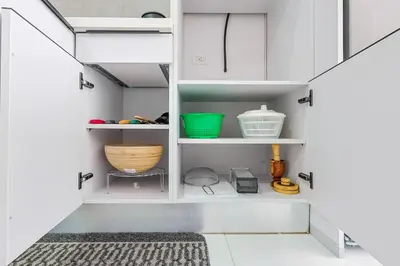 a kitchen with white cabinets and a rug at Upscale Condo, Spectacular Views in Santo Domingo
