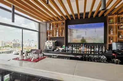 a bar with a view of a city at Comfy 1BR Apt, King Bed, Pool in Santo Domingo
