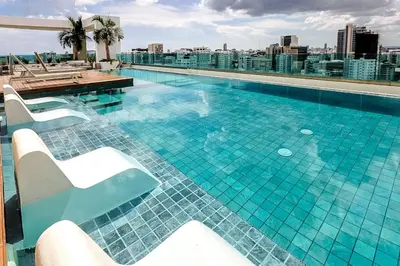 a swimming pool on the roof of a building at Cozy City-Center 1BD Condo, Pool in Santo Domingo