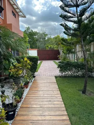 a wooden walkway in a garden with plants at Luxury Villa with Pool, jacuzzi,Basketball and more