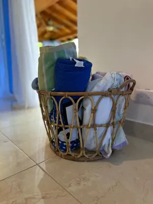 a basket filled with towels on a tile floor at Luxury Villa with Pool, jacuzzi,Basketball and more