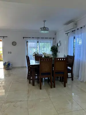 a dining room with a table and chairs at Luxury Villa with Pool, jacuzzi,Basketball and more