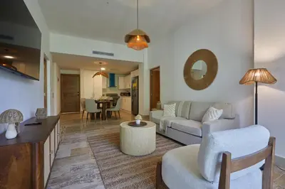 a living room with a couch and a table at Modern Escape with Pool & Beach in Puerto Plata